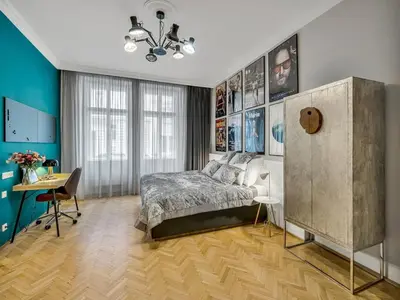 a bedroom with a bed and a desk in it at Design Spacy Apartman by City Center in Prague