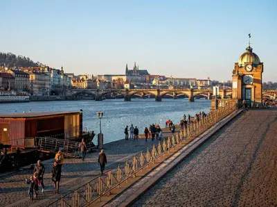 a group of people walking on a bridge over a river at Design Spacy Apartman by City Center in Prague
