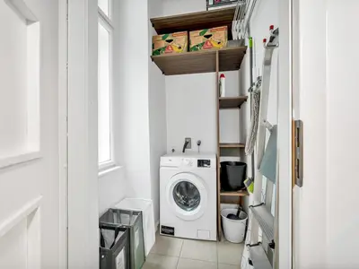 a laundry room with a washing machine and a window at Design Spacy Apartman by City Center in Prague