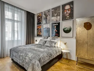 a bedroom with a bed and a bunch of movie posters at Design Spacy Apartman by City Center in Prague