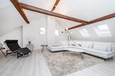 a living room with a white couch and a chair at Picturesque Apt in Lesser Town with lovely Terrace in Prague