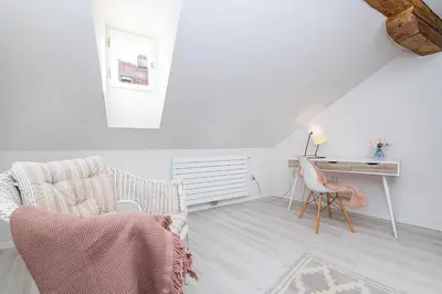 a white living room with a desk and a chair at Picturesque Apt in Lesser Town with lovely Terrace in Prague