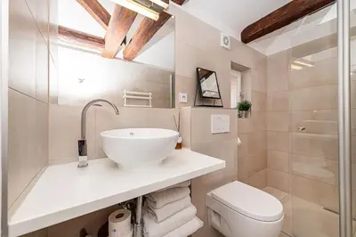 a bathroom with a sink and a toilet at Picturesque Apt in Lesser Town with lovely Terrace in Prague