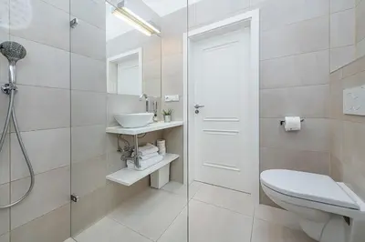 a bathroom with a toilet and a sink and a shower at Picturesque Apt in Lesser Town with lovely Terrace in Prague
