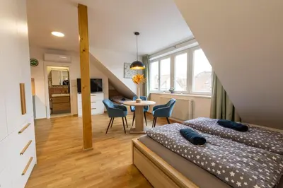 a bedroom with a wooden bed in the attic at Spoon Apartment Prague 2 in Prague
