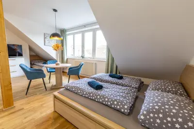 an empty kitchen with a table and a bench at Spoon Apartment Prague 2 in Prague