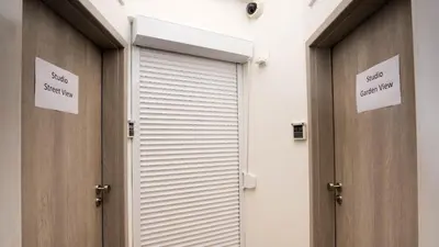 a pair of doors in a building with signs on them at Flying Bed Apartment close to Prague Castle and Airport in Prague