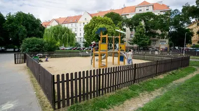 a playground in a park with people playing on it at Flying Bed Apartment close to Prague Castle and Airport in Prague