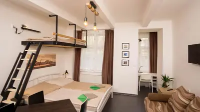 a bedroom with a bunk bed and a living room at Flying Bed Apartment close to Prague Castle and Airport in Prague