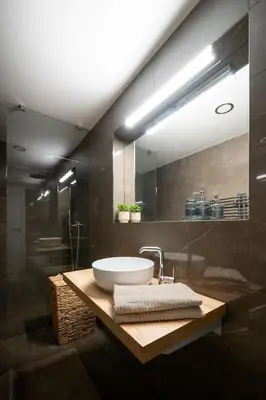 a bathroom with a sink and a mirror at Modern Studio in Karlin - Fully Equipped in Prague