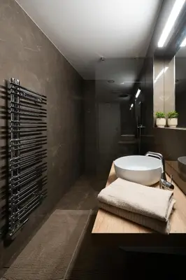 a bathroom with a white tub and a sink at Modern Studio in Karlin - Fully Equipped in Prague