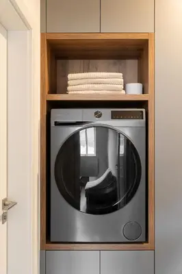 a microwave in a kitchen with a wooden cabinet at Modern Studio in Karlin - Fully Equipped in Prague