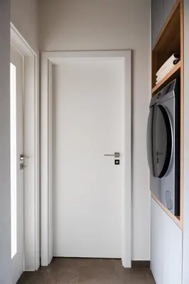 a white door with a microwave in a room at Modern Studio in Karlin - Fully Equipped in Prague