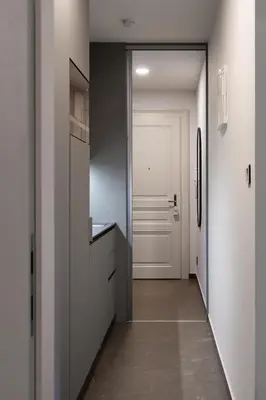 a kitchen with white cabinets and a white door at Modern Studio in Karlin - Fully Equipped in Prague