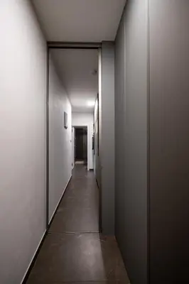 a hallway with white walls and a long corridor at Modern Studio in Karlin - Fully Equipped in Prague