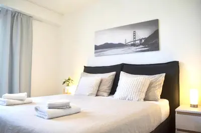 a bedroom with a large bed with two towels on it at Panorama Apartment with Parking in Prague