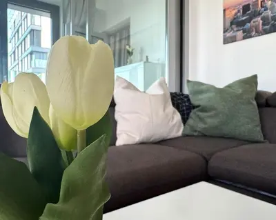 a living room with a couch and a large flower at Panorama Apartment with Parking in Prague