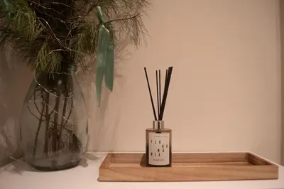 a wooden tray with sticks in it next to a vase at Panorama Apartment with Parking in Prague