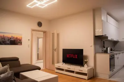 a living room with a flat screen tv on a table at Panorama Apartment with Parking in Prague