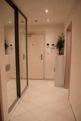 an empty hallway with a door and a refrigerator at Panorama Apartment with Parking in Prague