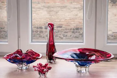 two red glass vases sitting on a table at Kovárna Klapý pod Hazmburkem - České středohoří in Klapý