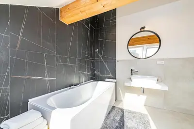a bathroom with a white tub and a sink at Rooftop APT with beautiful view and free parking in Prague