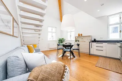 a living room with a couch and a table at Rooftop APT with beautiful view and free parking in Prague