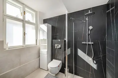 a bathroom with a shower and a toilet at Rooftop APT with beautiful view and free parking in Prague