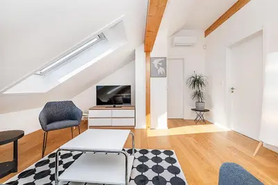 an attic living room with a skylight at Rooftop APT with beautiful view and free parking in Prague