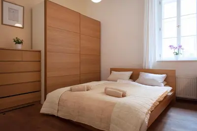 a bedroom with a large bed with two pillows on it at Cozy apt in the heart of Old town in Prague