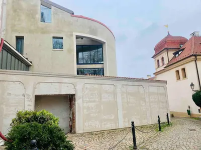 a large building with a garage in front of a house at Cozy apt in the heart of Old town in Prague