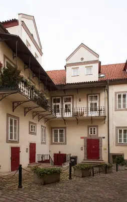 a group of buildings with red doors and balconies at Cozy apt in the heart of Old town in Prague