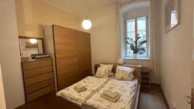 a bedroom with a bed and a dresser and a window at Cozy apt in the heart of Old town in Prague