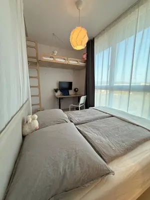 a bedroom with a large bed and a window at Easy City Access Bright 1BR with Underground Parking in Prague