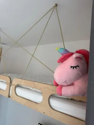 a pink stuffed animal is sitting on a shelf at Easy City Access Bright 1BR with Underground Parking in Prague