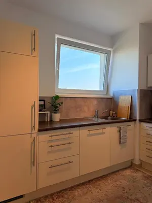 a kitchen with a sink and a window at Easy City Access Bright 1BR with Underground Parking in Prague