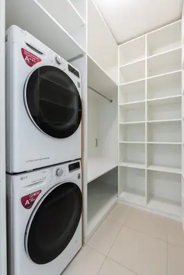 a washer and dryer in a white closet at Stylish 2BDR Apartment with Free Parking & Terrace by EasyBNB Premium in Prague