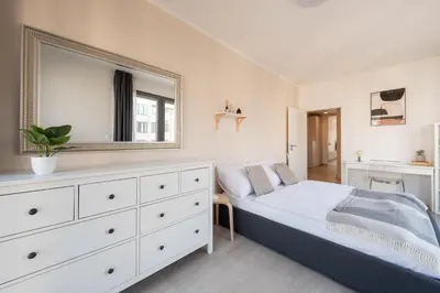 a bedroom with a bed with a mirror and a dresser at Stylish 2BDR Apartment with Free Parking & Terrace by EasyBNB Premium in Prague