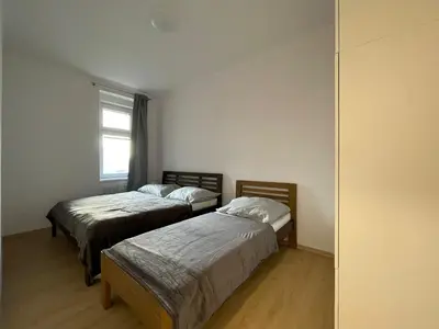 a bedroom with two beds and a window at Cozy & Spacious Apartment for 5 Guests in Prague in Prague