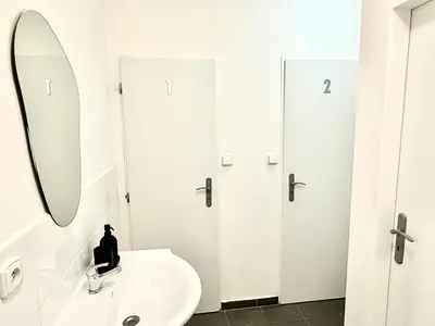 a white bathroom with a sink and a mirror at MiSTO 16 in Prague