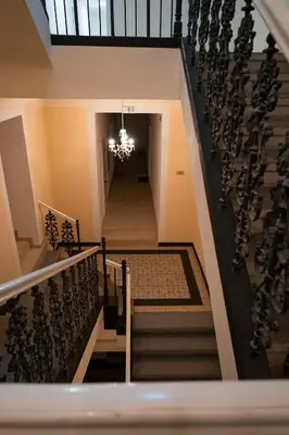 a staircase in a building with a chandelier at Stylish Studio in the Heart of Prague in Prague