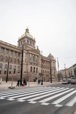 a large building with a crosswalk in front of a street at Stylish Studio in the Heart of Prague in Prague