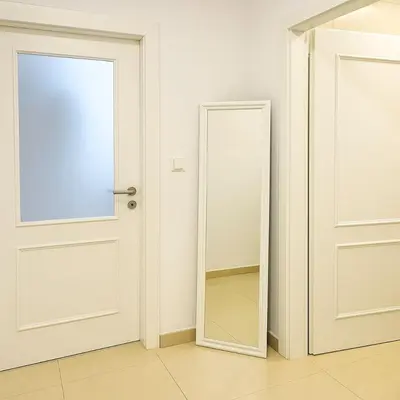 a white door with a mirror in a room at Stylish Studio in the Heart of Prague in Prague