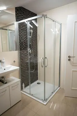 a bathroom with a shower with a glass enclosure at Stylish Studio in the Heart of Prague in Prague