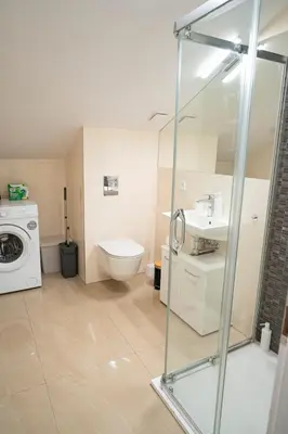 a bathroom with a toilet and a sink and a washing machine at Stylish Studio in the Heart of Prague in Prague