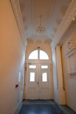 an empty hallway with a door with a window at Stylish Studio in the Heart of Prague in Prague