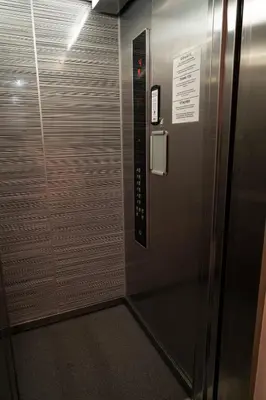 a elevator with a metal door with a sign on it at Stylish Studio in the Heart of Prague in Prague