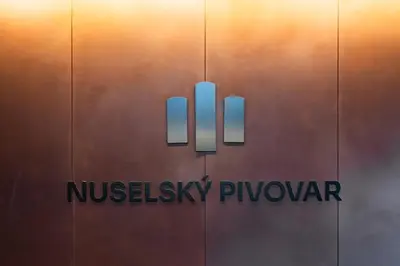 a sign on the side of a building with the nkissiki pyyu at Nusle Brewery Design Apartment in Prague