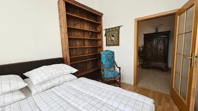 a bedroom with a bed and a chair in it at Grand Prague Residence in Prague