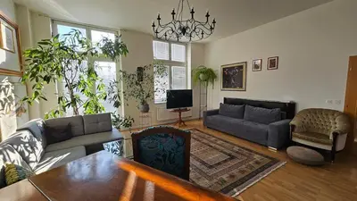 a living room with a couch and a table at Grand Prague Residence in Prague